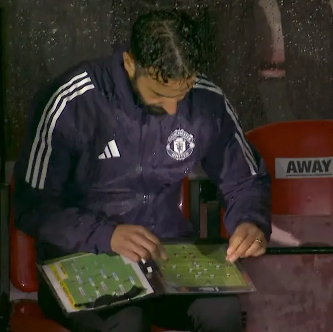 Ruben Amorim shuffling magnets around his tactics board in the rain during the Grimsby Town defeat