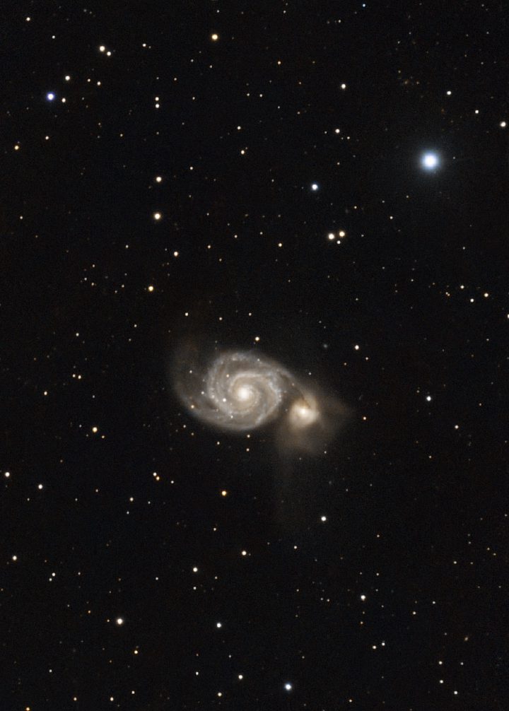Astrophotograph of M51, the Whirlpool Galaxy, showing its spiral arms and the smaller companion galaxy NGC 5195