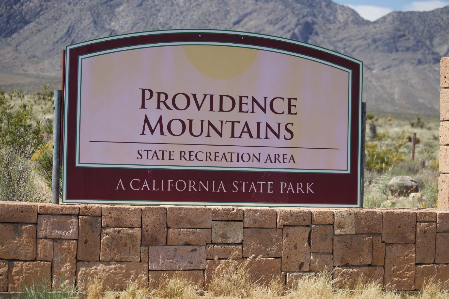 Wooden entrance sign reading Providence Mountains State Recreation Area at Mitchell Caverns, Mojave Desert, California